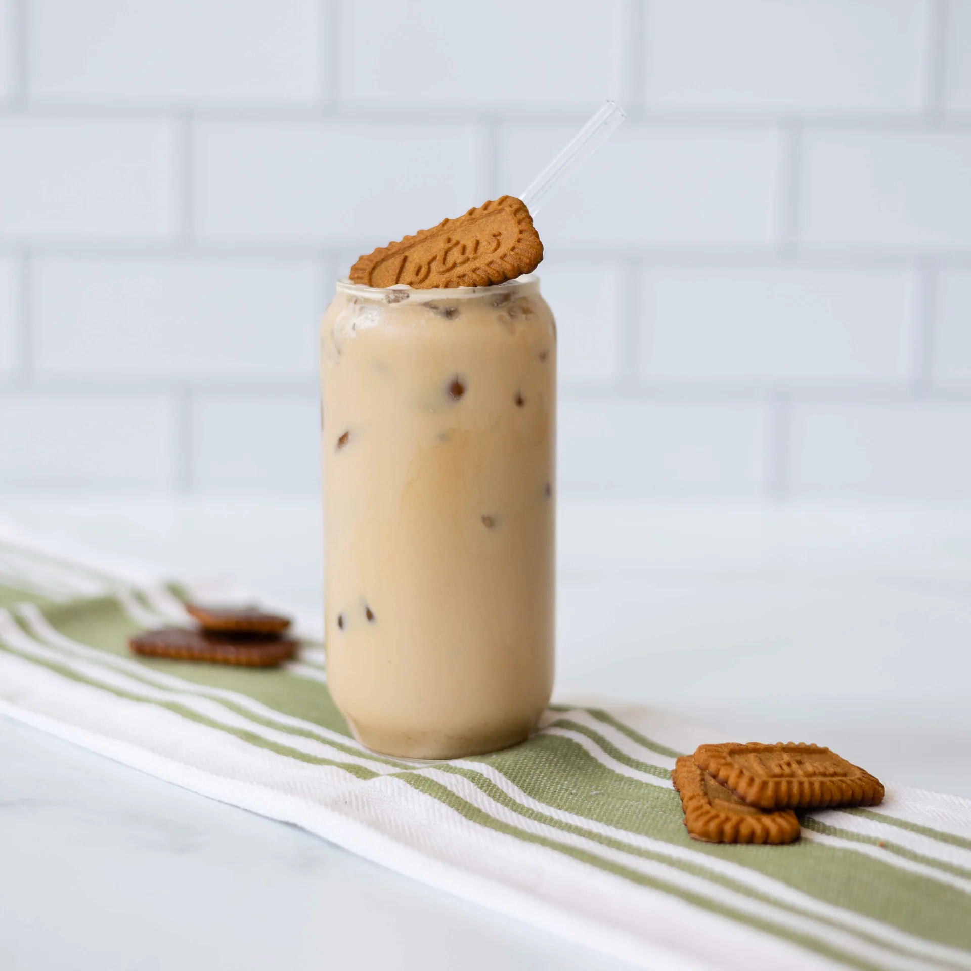 Iced Biscoff Latte in glass with biscoff biscuit on top